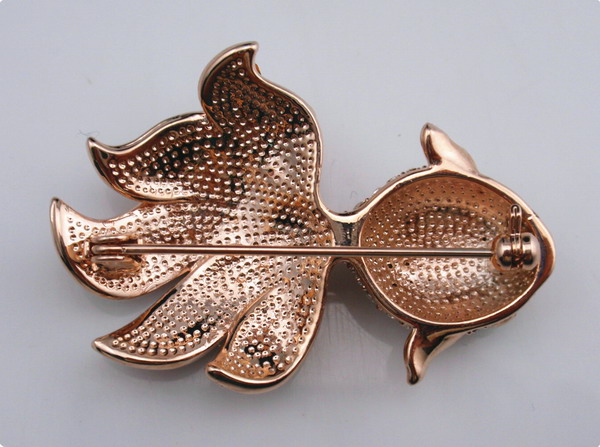 Fish shaped metal brooch